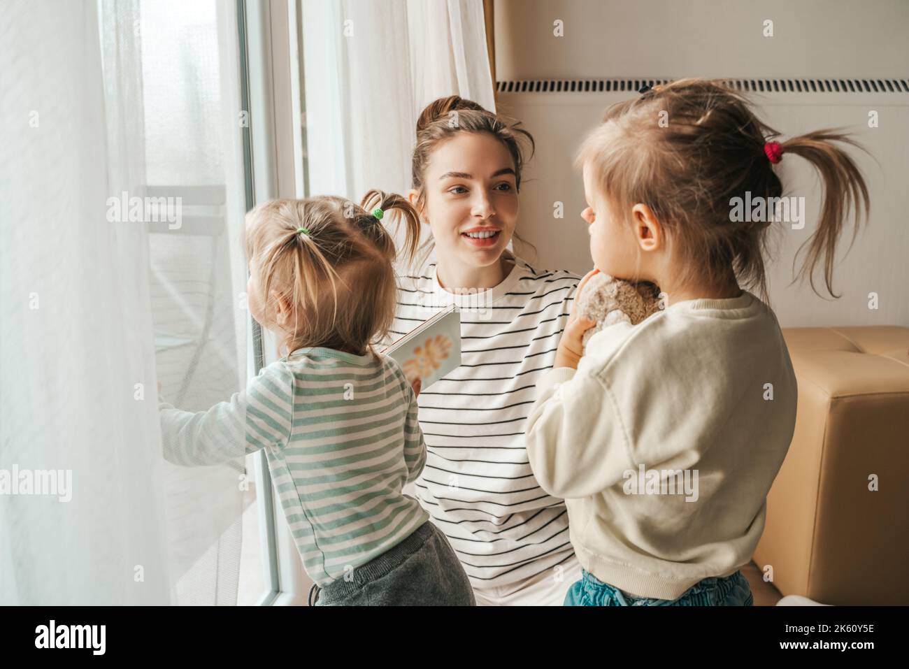 Affectionate mother spending time with her kids Stock Photo