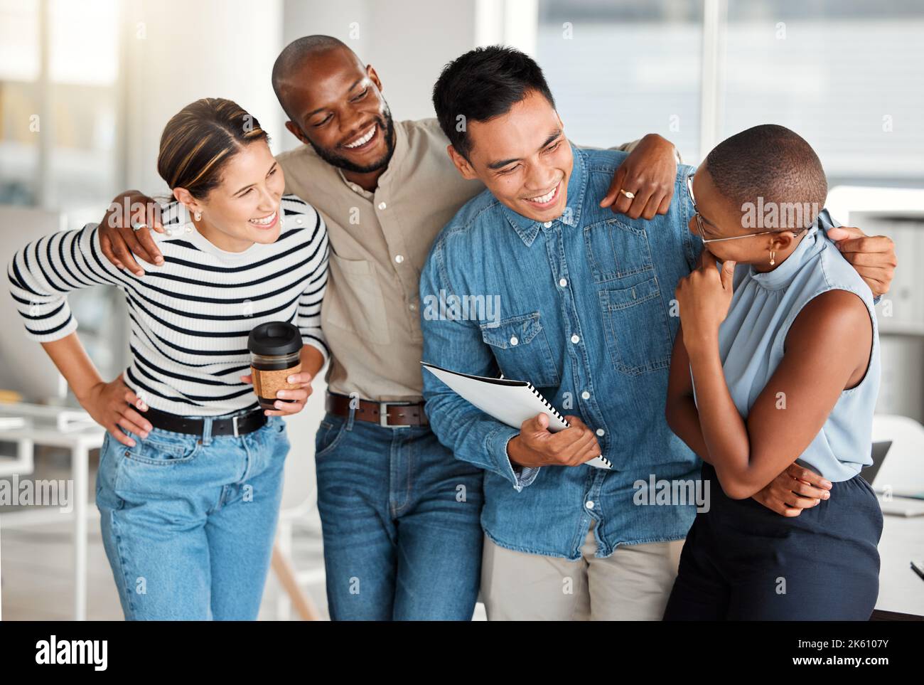 Group of diverse cheerful businesspeople spending time in an office together at work. Joyful business professionals smiling while bonding at work Stock Photo