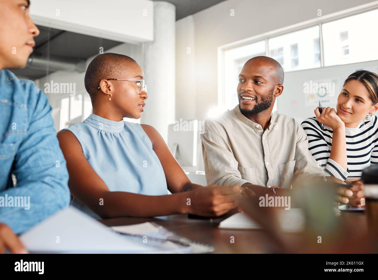 Group of serious focused diverse businesspeople having a meeting in an ...