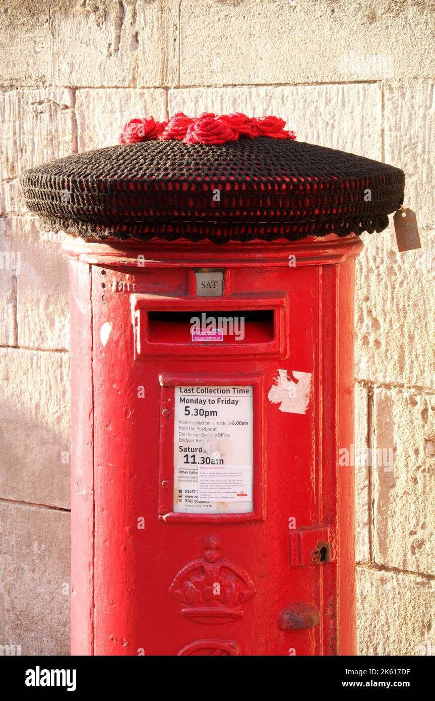 A black knitted woollen hat covers a red pillar box. Commemorating the ...