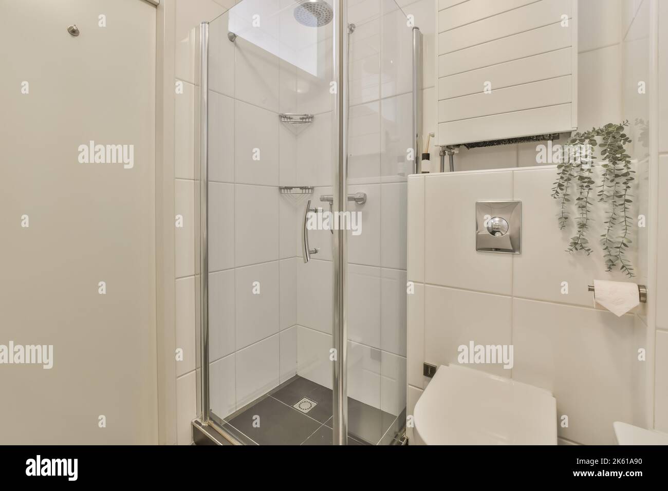 Interior of modern bathroom with white toilet bowl near glass wall of ...