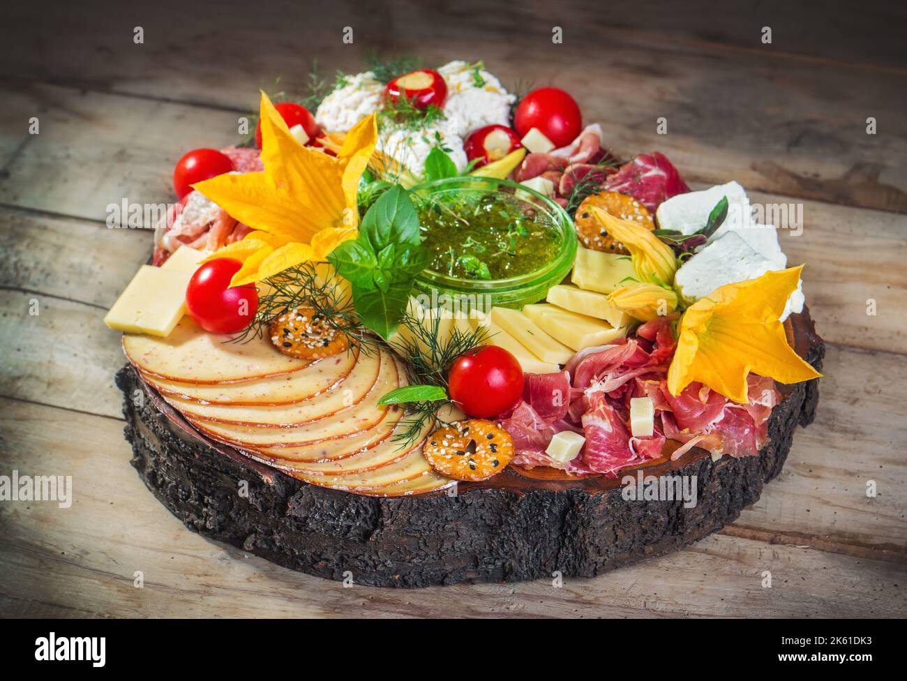 Antipasto food board with different types of cheese, curied meats