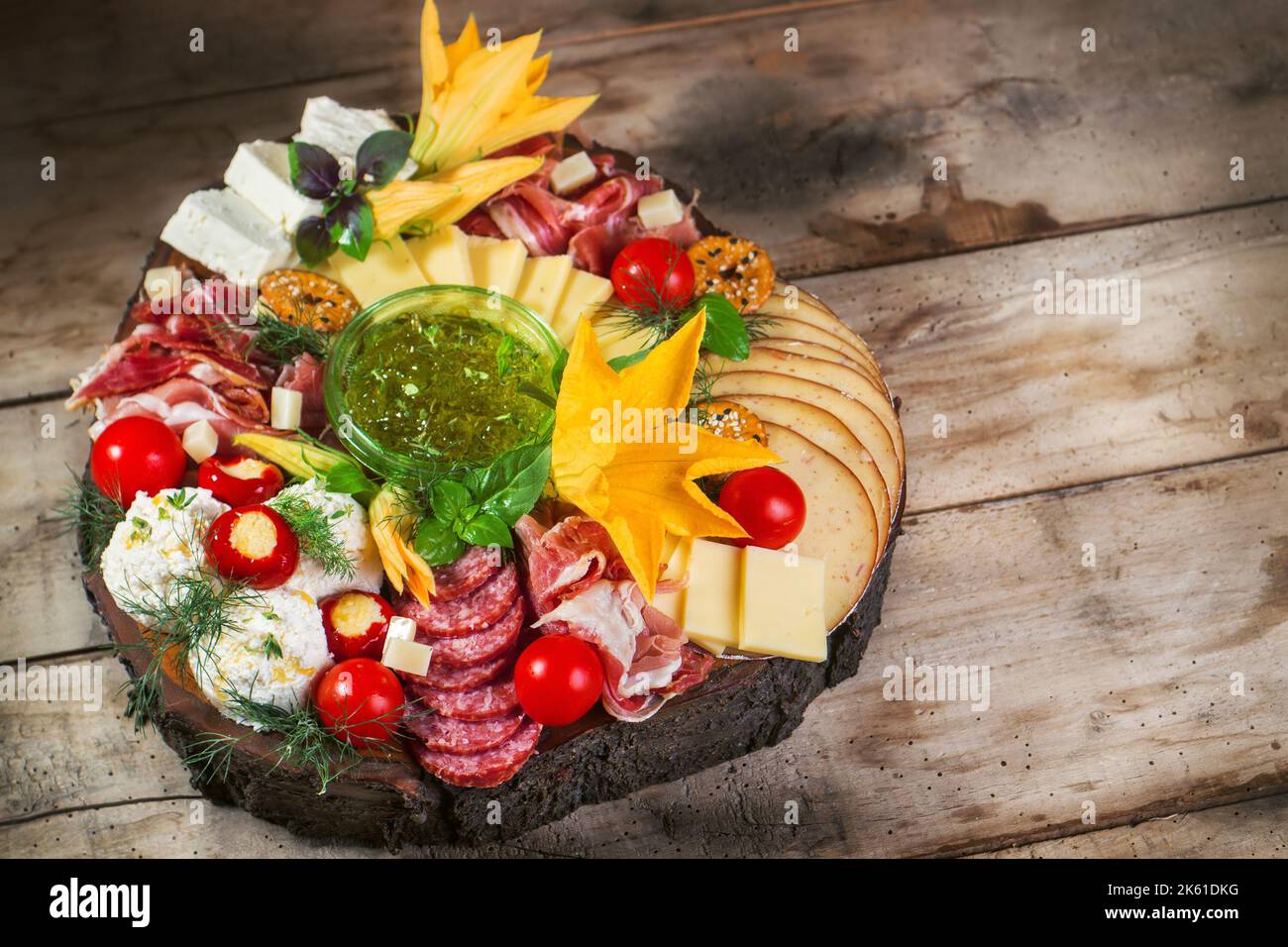 Antipasto food board with different types of cheese, curied meats