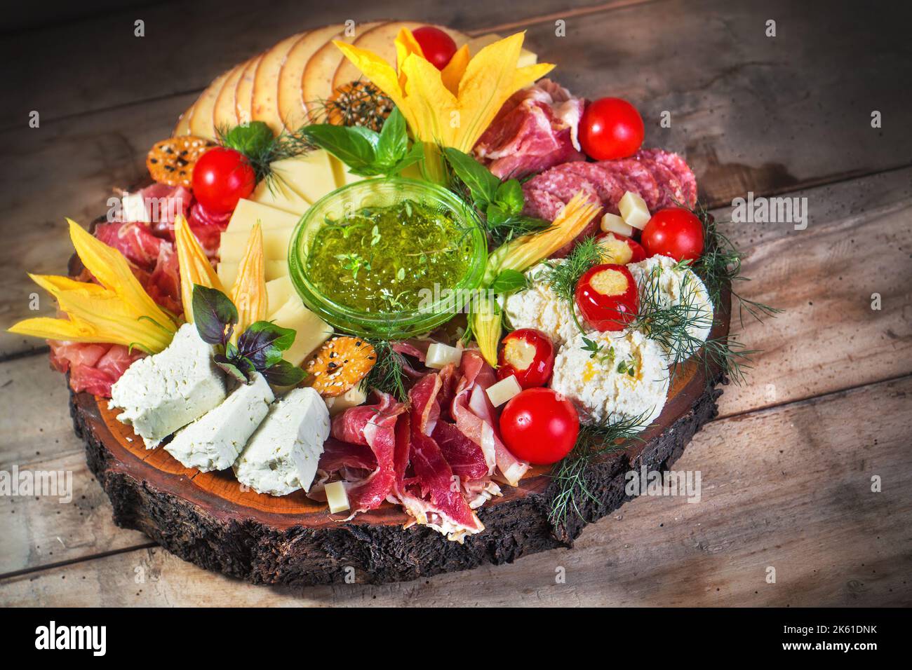 Antipasto food board with different types of cheese, curied meats