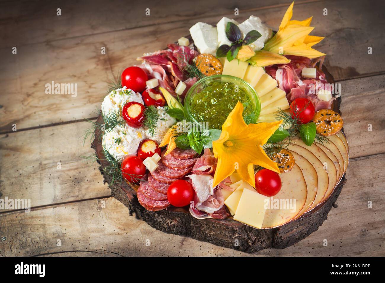 Antipasto food board with different types of cheese, curied meats