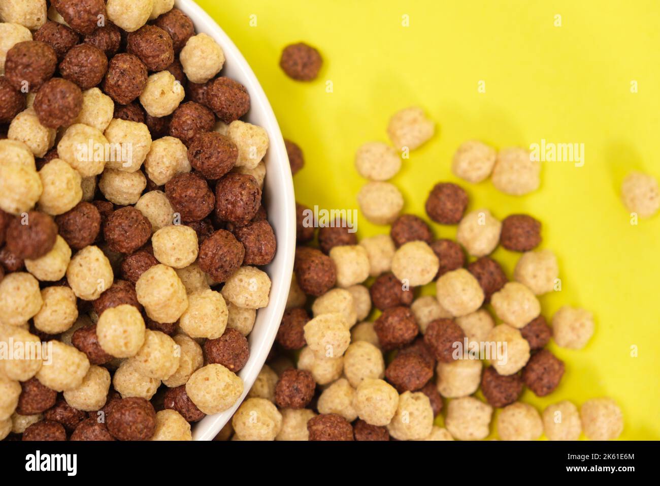 Corn balls with cocoa on a yellow background. Quick cereal healthy