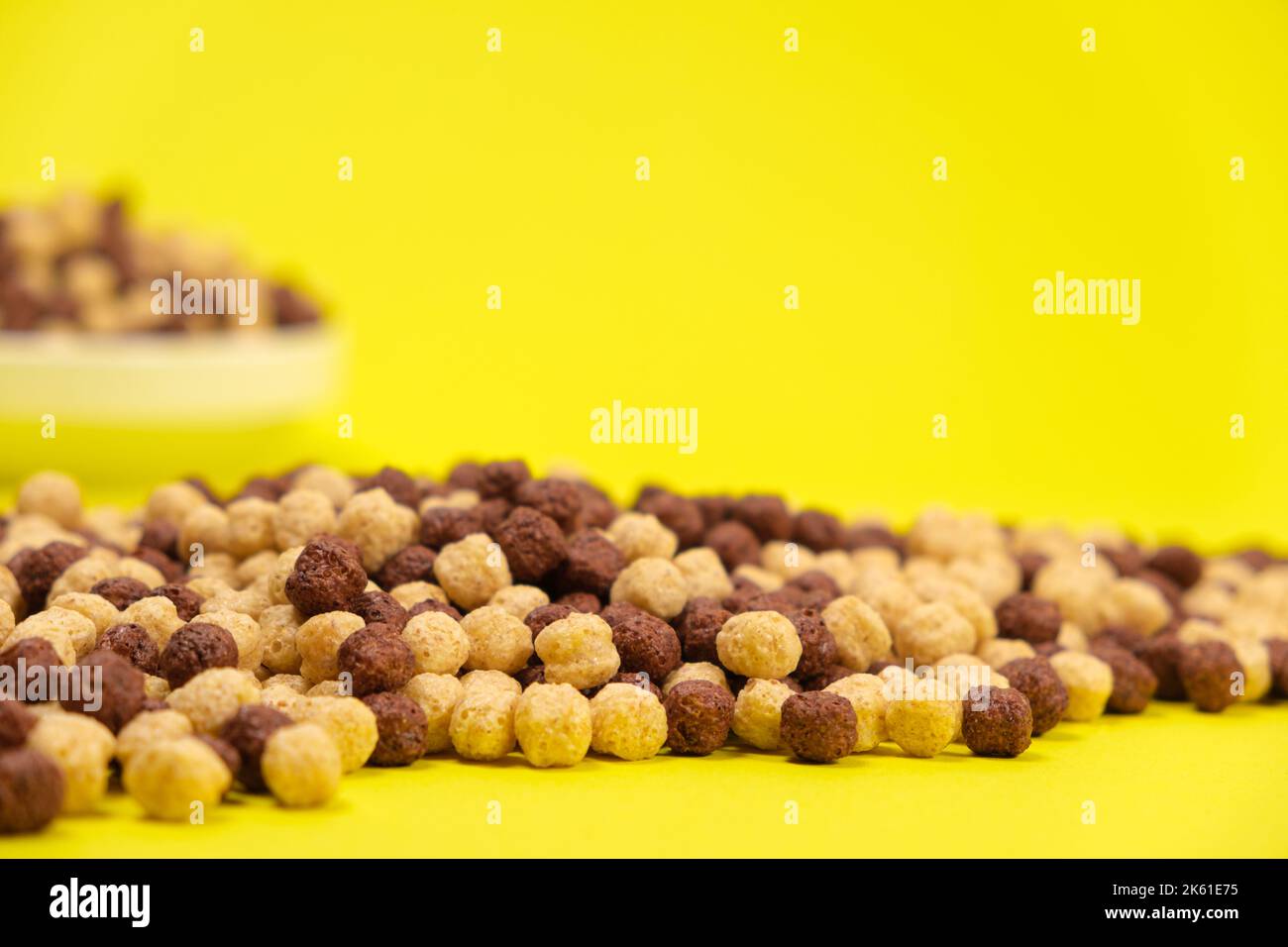 Corn balls with cocoa on a yellow background. Quick cereal healthy