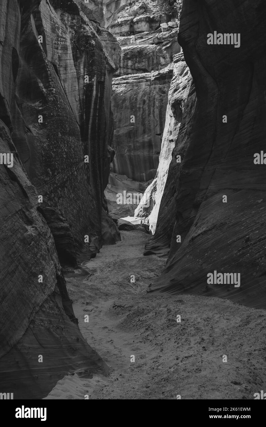 Light Creeps Around The Corner of a Slot Canyon In Black And White in