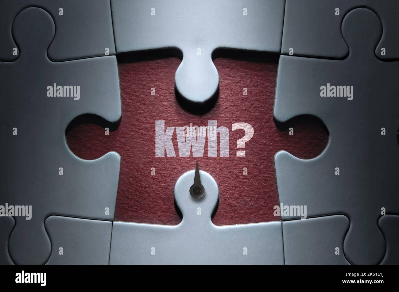 Missing piece from a jigsaw puzzle with dial pointing to kwh with question mark; energy usage concept Stock Photo