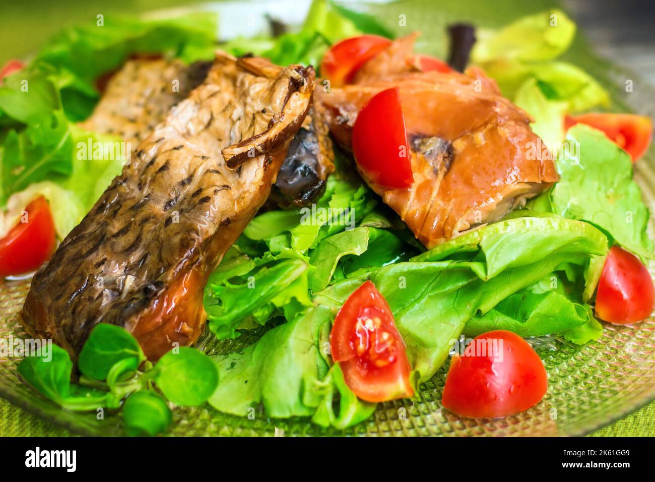 Smoked sea bream and salmon carpaccio with lettuce and cherry tomatoes (selective focus) Stock Photo