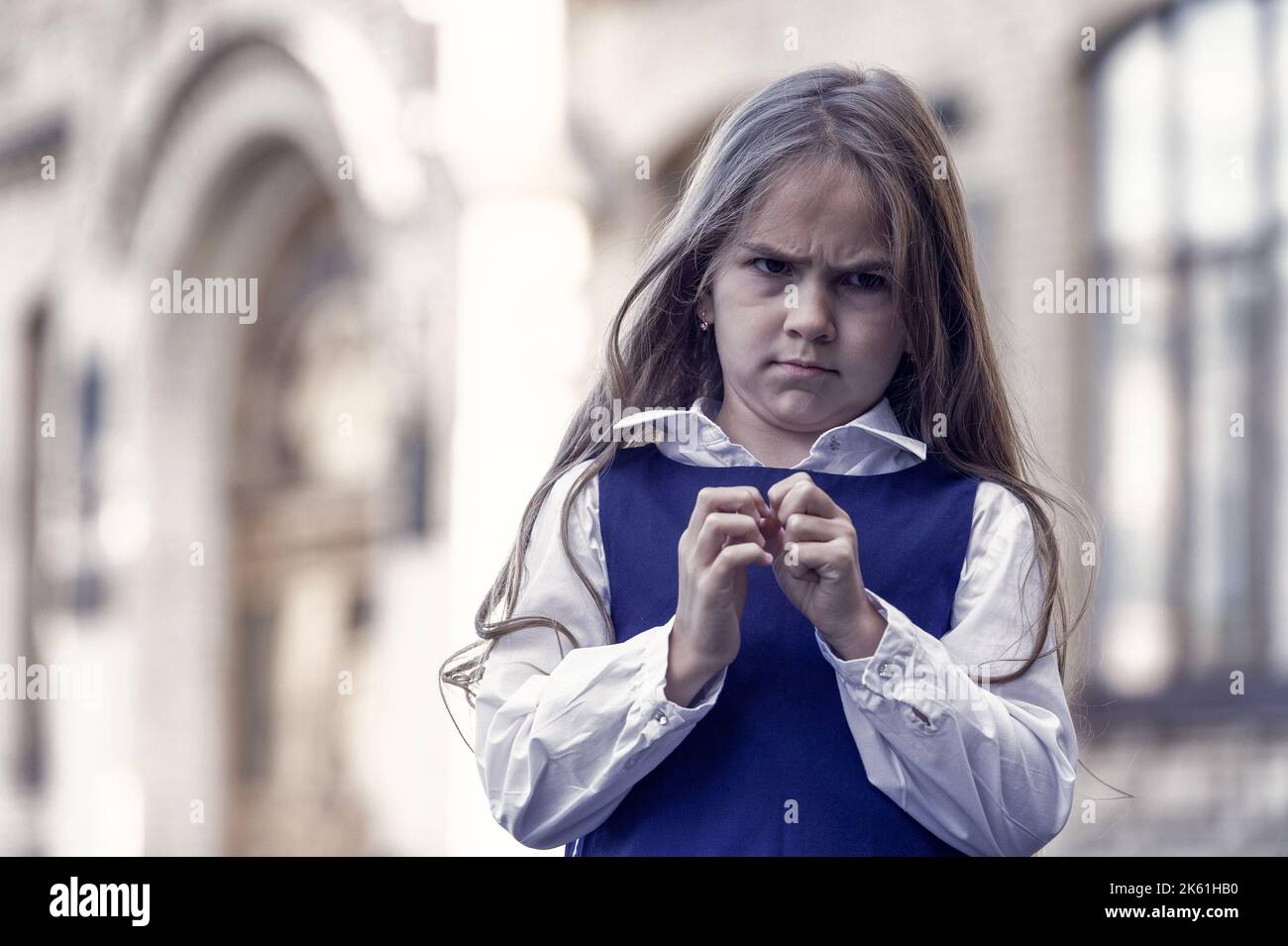 I hate school. Naughty girl child. Unhappy girl back to school. Wearing fashion uniform. Formal education. September 1. Knowledge day. Feeling dread Stock Photo