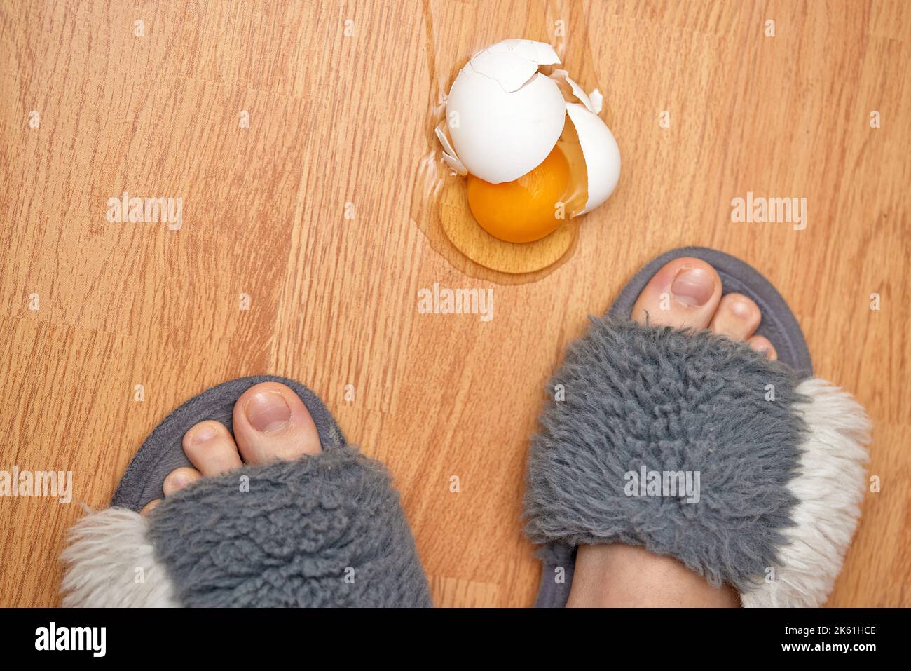 broken egg and feet on the floor in kitchen Stock Photo