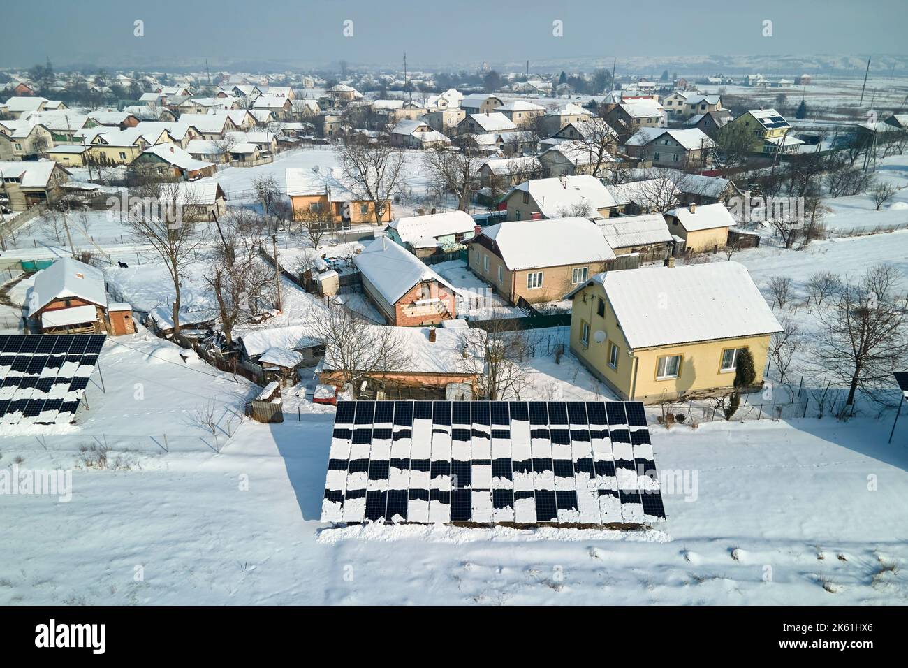 Aerial view of snow melting from covered solar photovoltaic panels