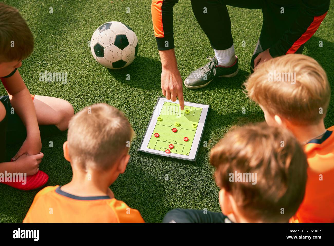 Football training. Soccer coach explaining game rules and strategy