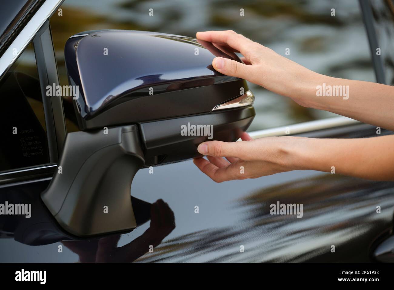 Driver hands adjusting side view mirror of a car Stock Photo Alamy