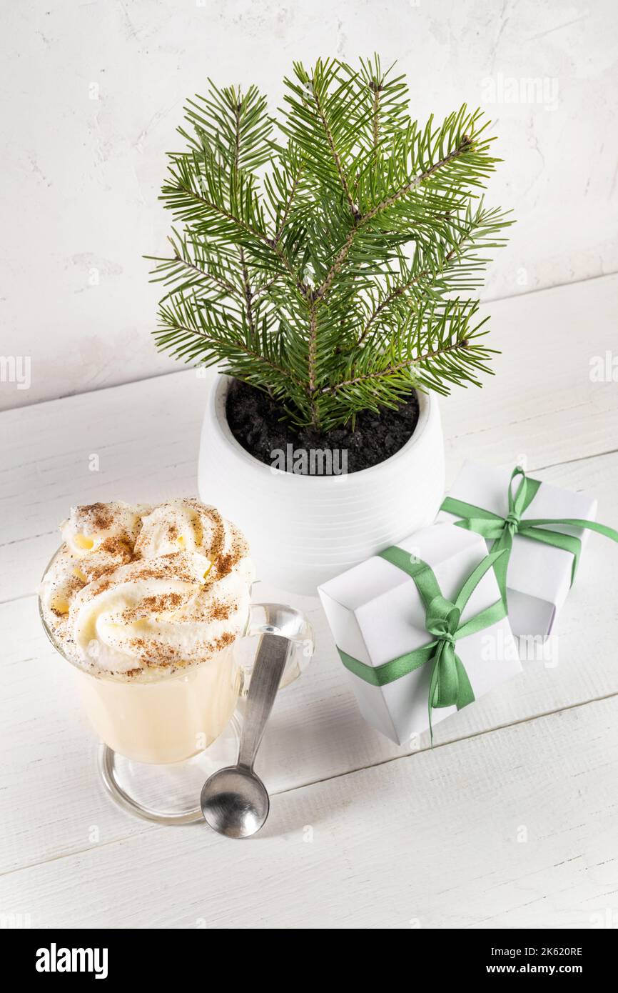 Christmas image with traditional holiday drink Glass of dairy eggnog
