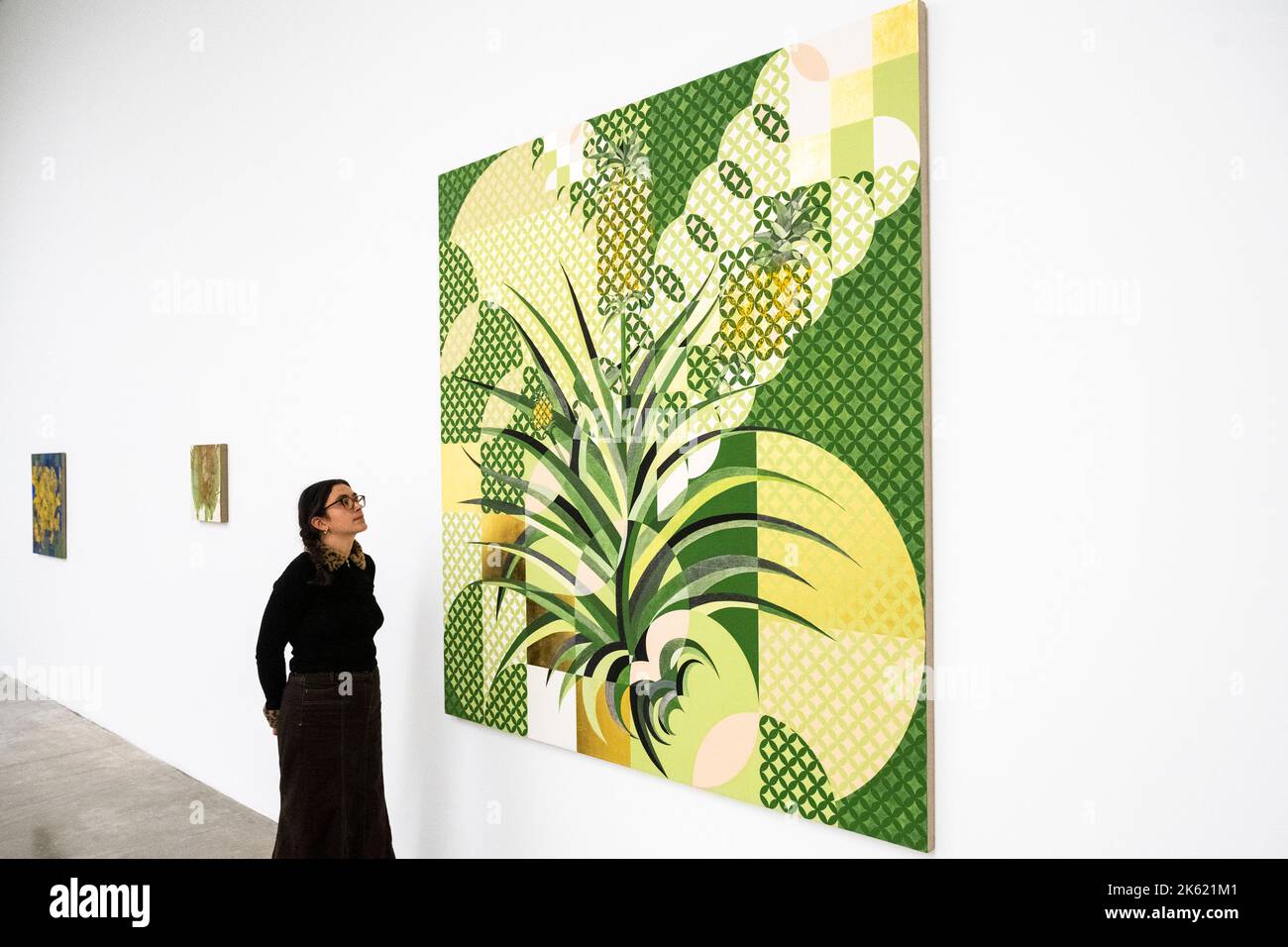 London, UK.  11 October 2022. A staff member with 'Pineapple', 2022, by Gabriel Orozco at the preview of ‘Diario de Plantas’, a new exhibition by artist Gabriel Orozco at White Cube, Mason’s Yard, in Mayfair.  The leaf print-inspired works began as entries in small notebooks during a period of time spent in Tokyo and Mexico City.  The exhibition runs 12 October to 12 November 2022. Credit: Stephen Chung / Alamy Live News Stock Photo