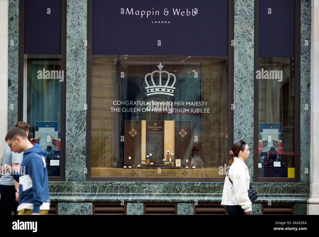 Platinum Jubilee decorations are seen drawn on the window of a retail