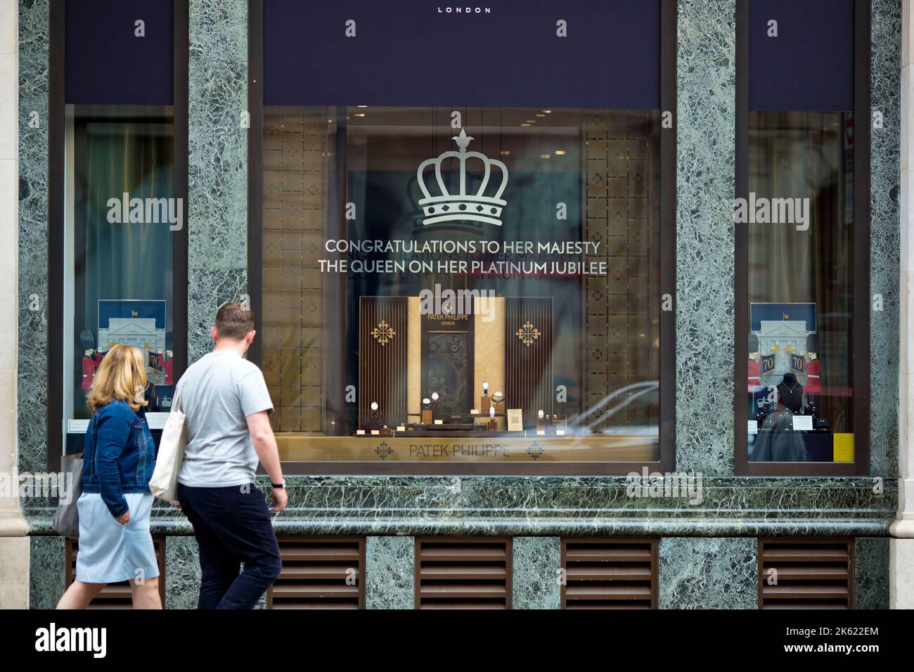 Platinum Jubilee decorations are seen drawn on the window of a retail