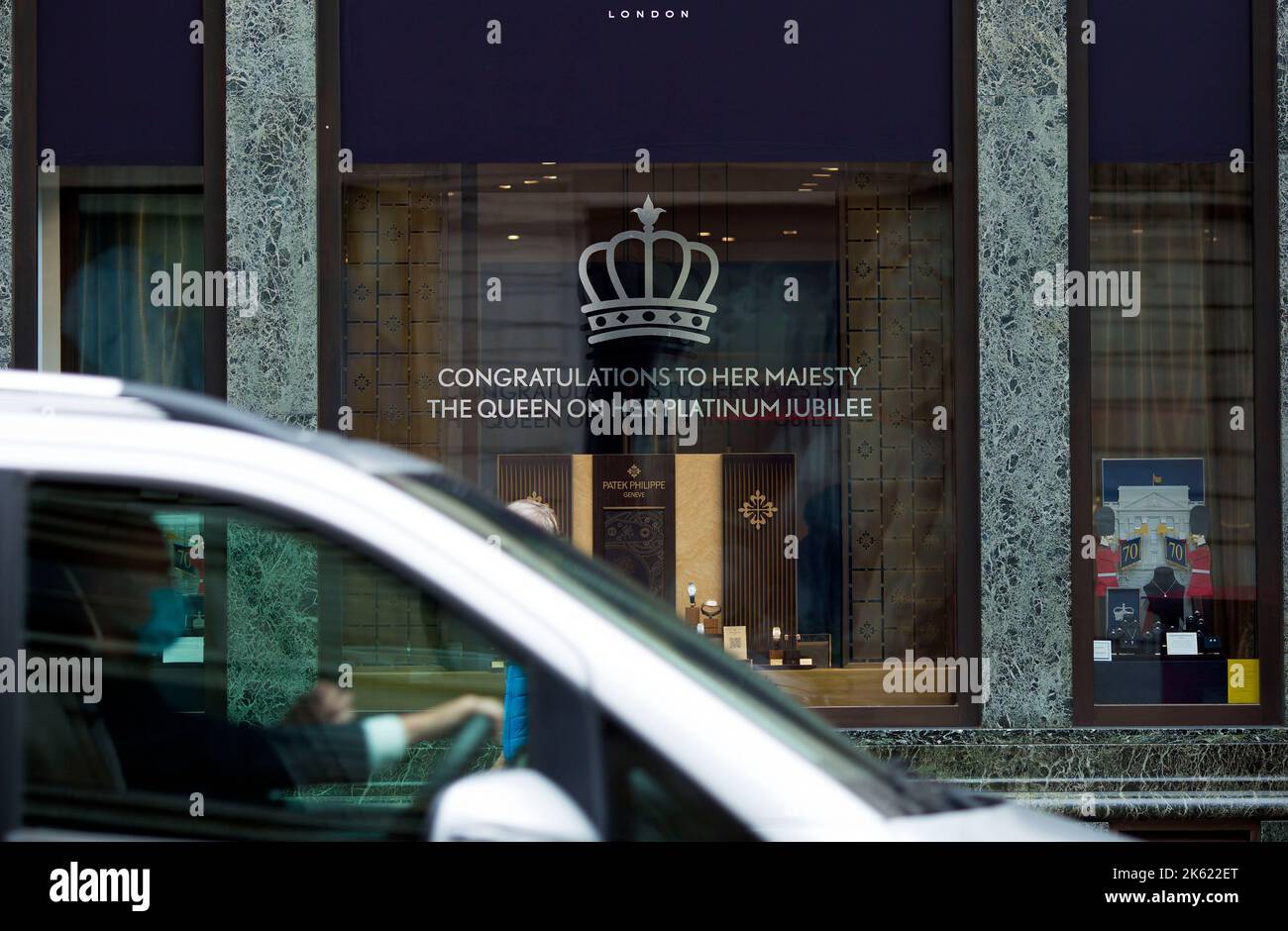 Platinum Jubilee decorations are seen drawn on the window of a retail