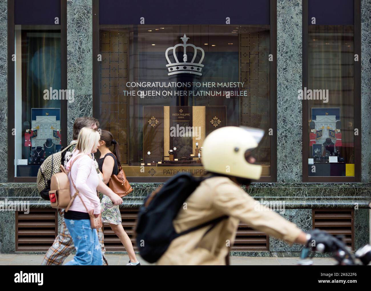 Platinum Jubilee decorations are seen drawn on the window of a retail