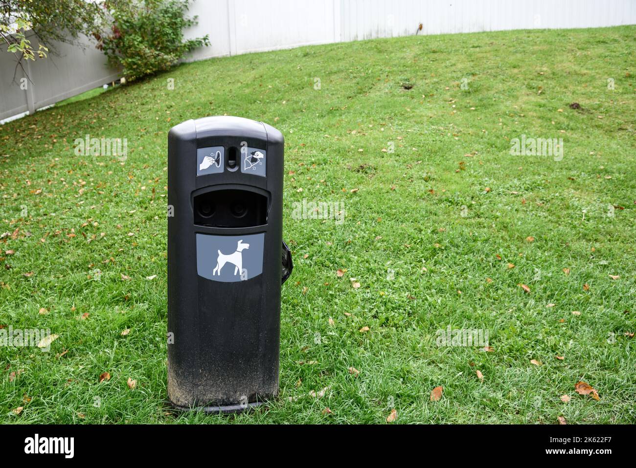 Close up of a dog waste bin on grass on a public park Stock Photo
