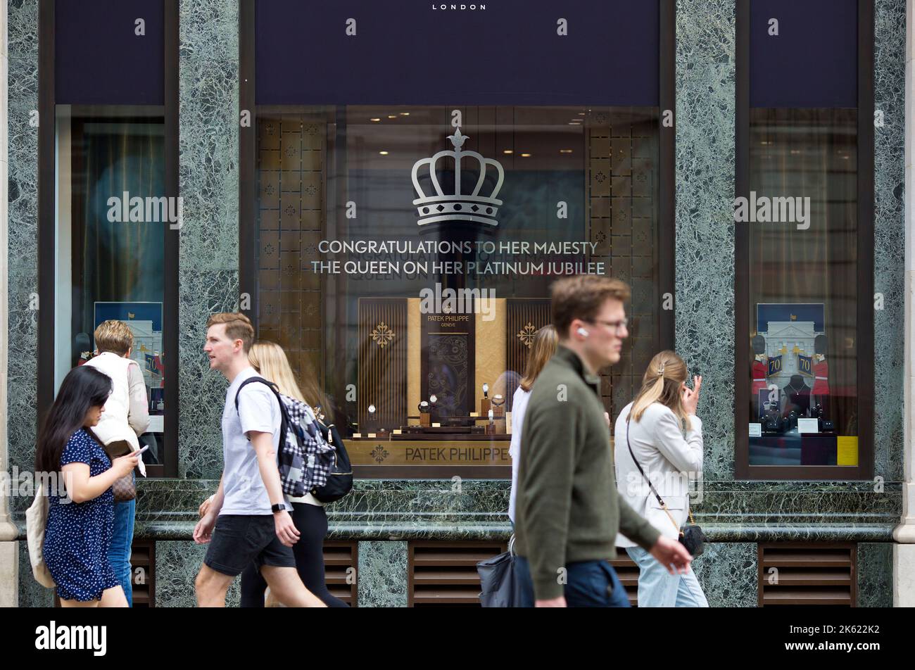 Platinum Jubilee decorations are seen drawn on the window of a retail