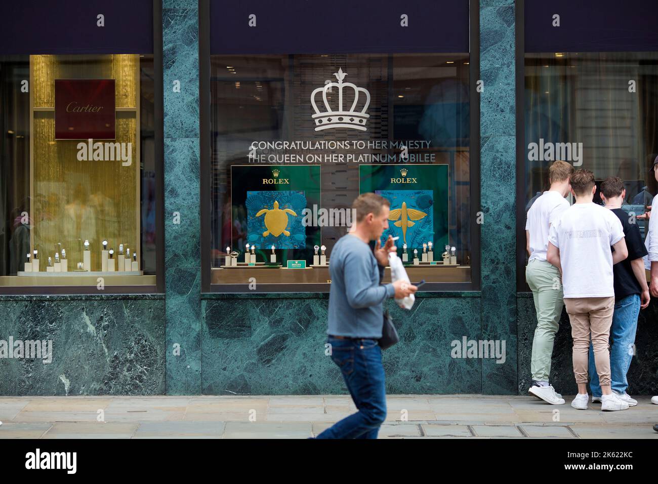 Platinum Jubilee decorations are seen drawn on the window of a retail