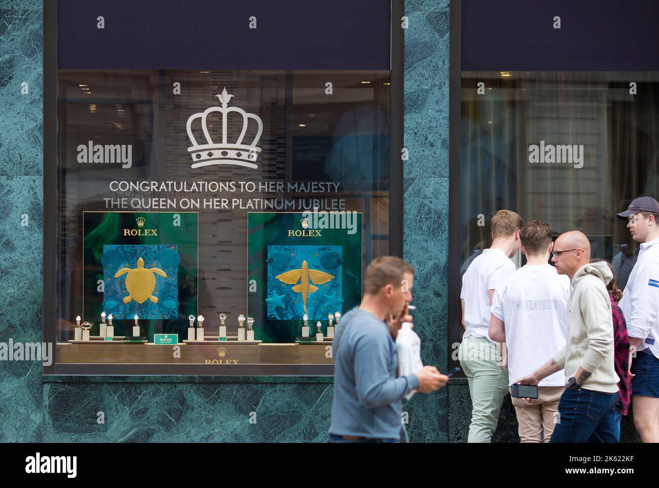 Platinum Jubilee decorations are seen drawn on the window of a retail