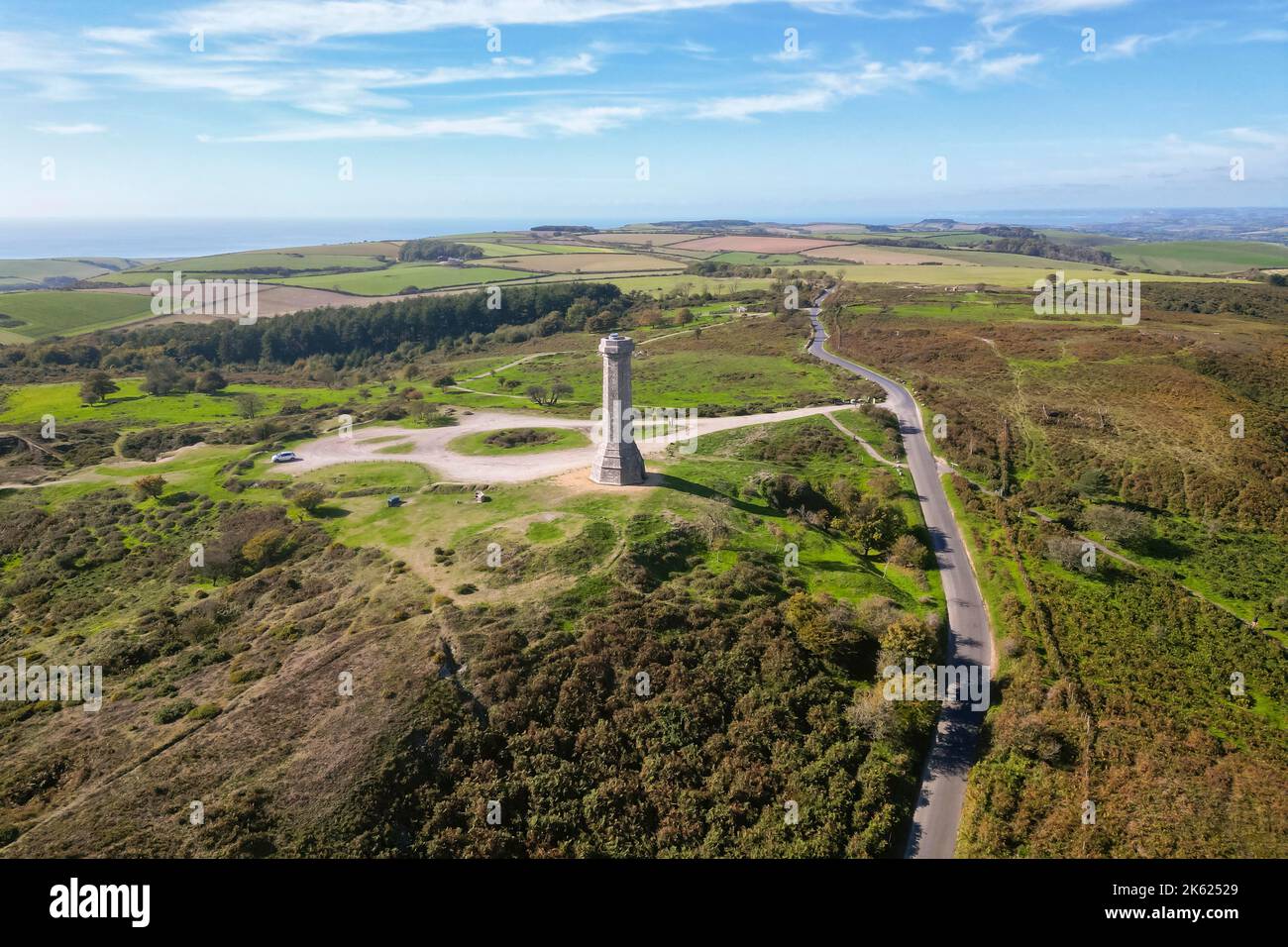 Portesham, Dorset, UK.  11th October 2022.  UK Weather.  View from the air of Hardy Monument on Black Down near Portesham in Dorset on a warm clear sunny autumn afternoon.  The monument is 72 foot high and was erected in 1844 by public subscription in memory of Vice Admiral Sir Thomas Masterman Hardy, flag captain of Admiral Lord Nelson at the Battle of Trafalgar. Picture Credit: Graham Hunt/Alamy Live News Stock Photo