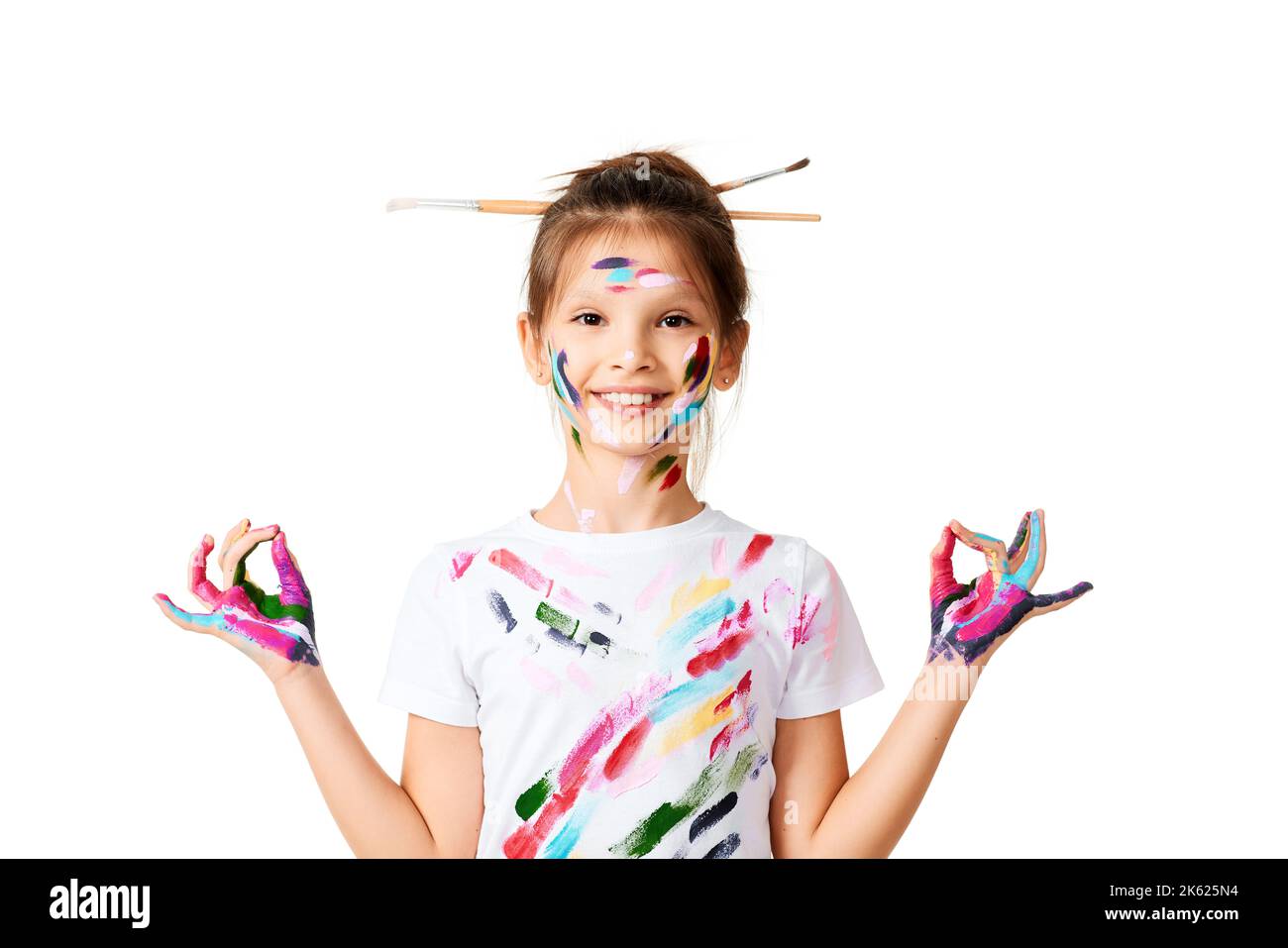 child girl with hands painted in colorful paint make heart shape Stock Photo