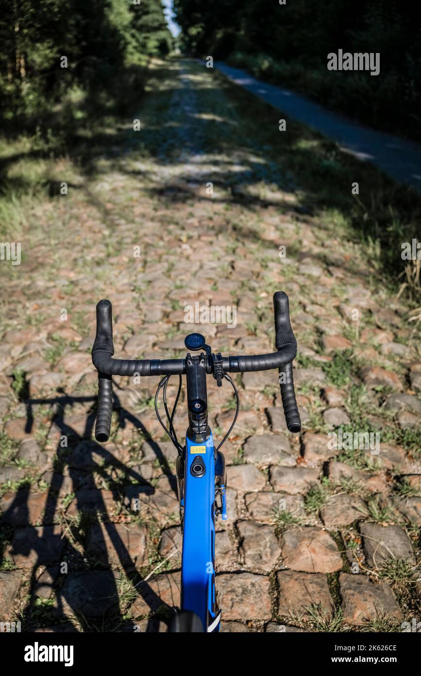 Rider view of the Arenberg cobbles from the Paris Roubaix cycle race route, northern France. Stock Photo
