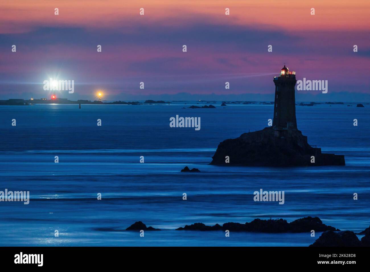 Night exposure of the famous La Vieille lighthouse illuminated with Sein island and Ar-Men lighthouse at the back, Brittany, France Stock Photo