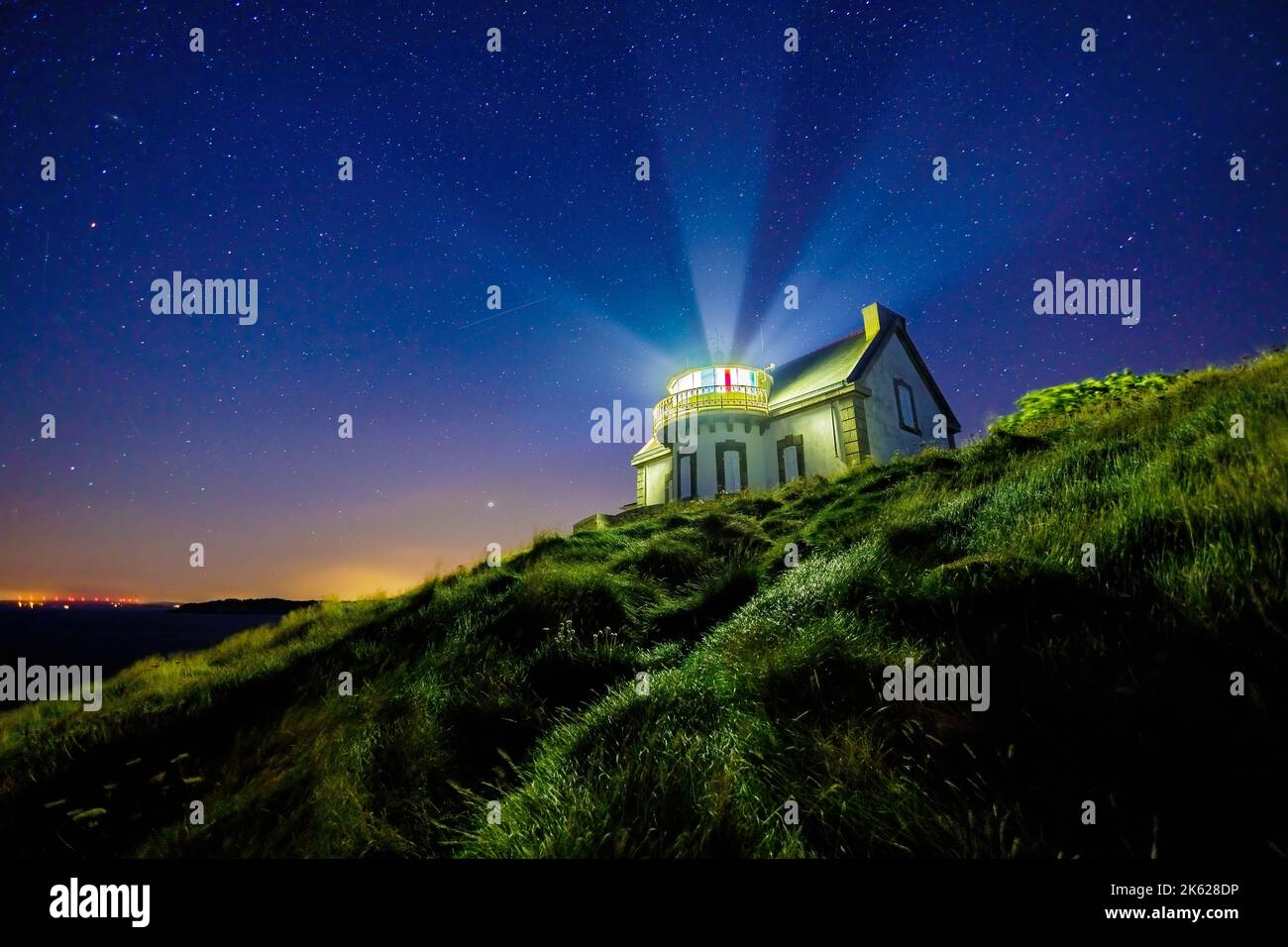 The Millier point lighthouse under a starry clear sky, Brittany, France Stock Photo