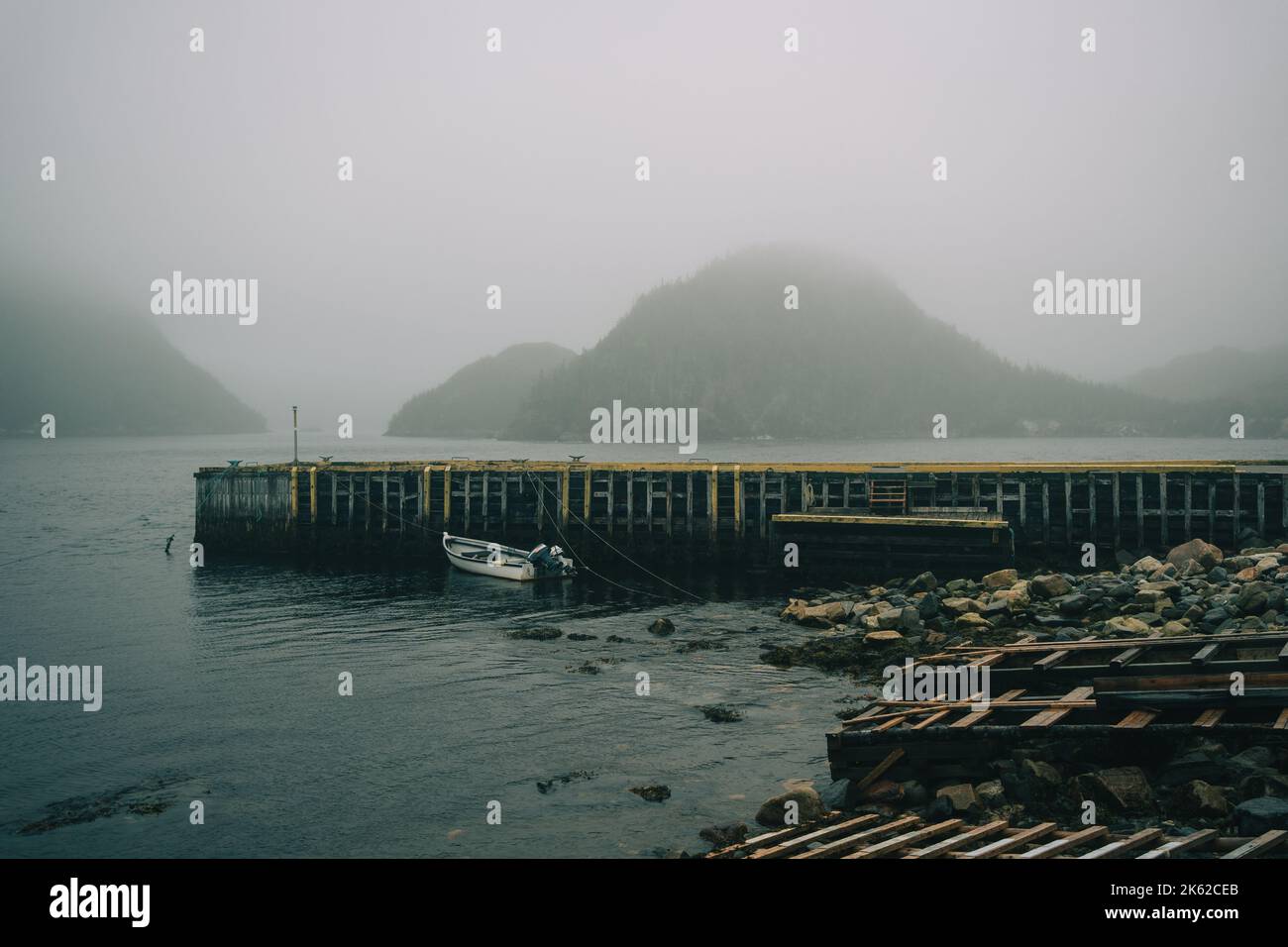 Pier with view of mountains on a foggy evening, Rose Blanche-Harbour le Cou, Newfoundland and Labrador, Canada Stock Photo