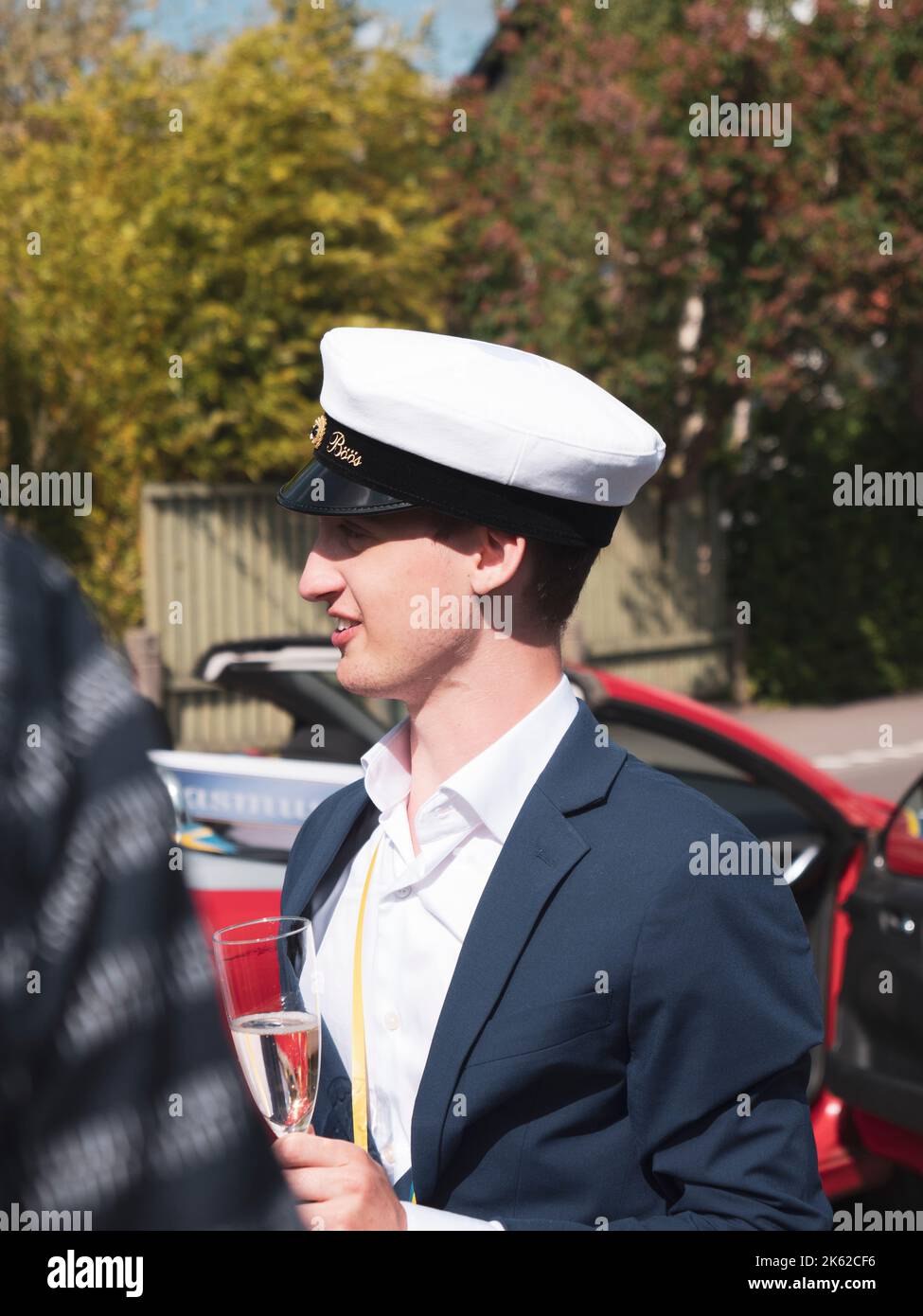 A newly graduated Swedish student celebrating his high school graduation with glass of champagne Stock Photo