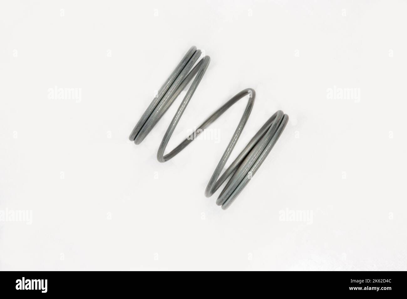 Metal spring coil closeup on white Stock Photo Alamy