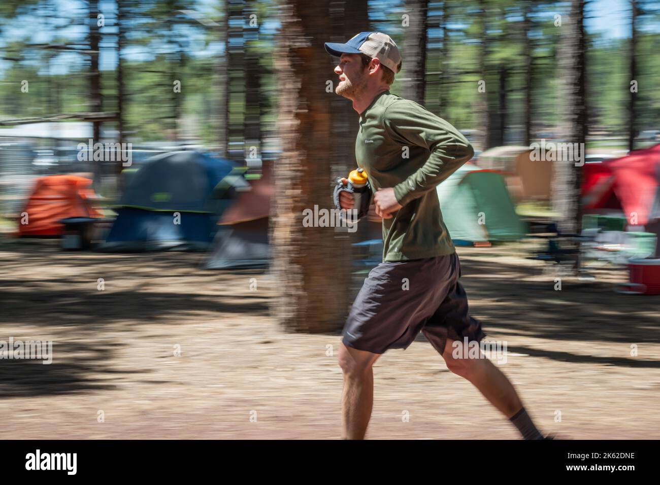 Man running through the woods at Fort Tuthill County Park while