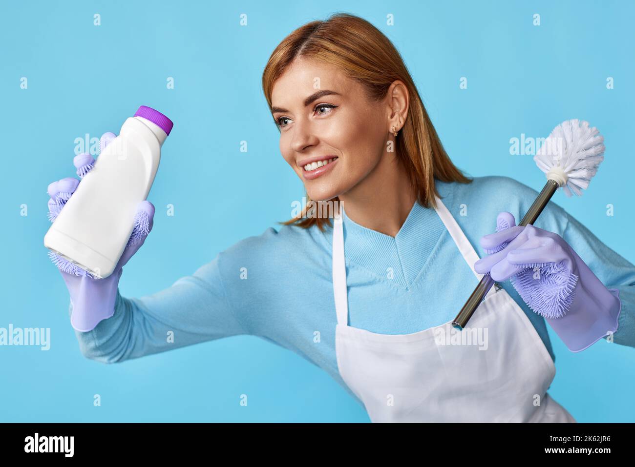 woman in rubber gloves holding toilet brush and bottle of detergent Stock Photo Alamy