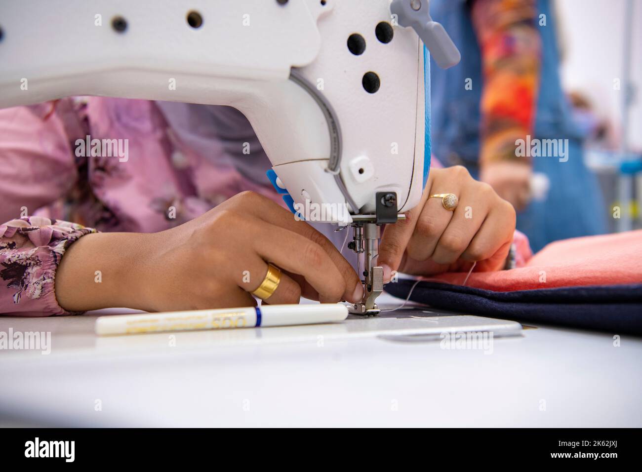 WOMAN STITCHING Stock Photo