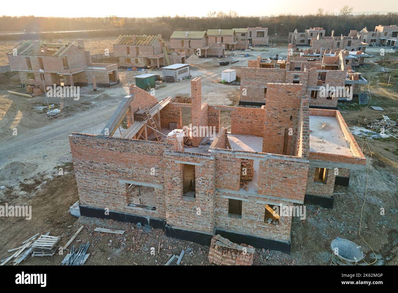 Aerial view of residential houses under construction in rural suburban area. Real estate