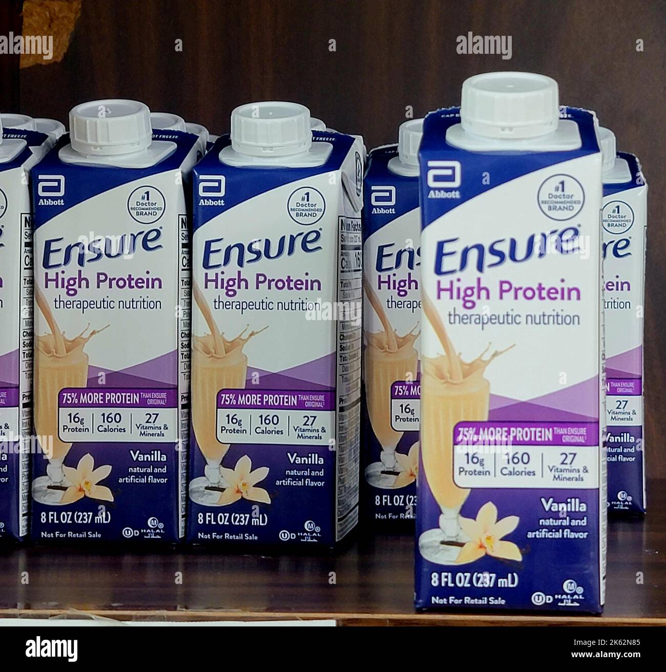 A row of plastic bottles of Ensure High Protein therapeutic nutrition