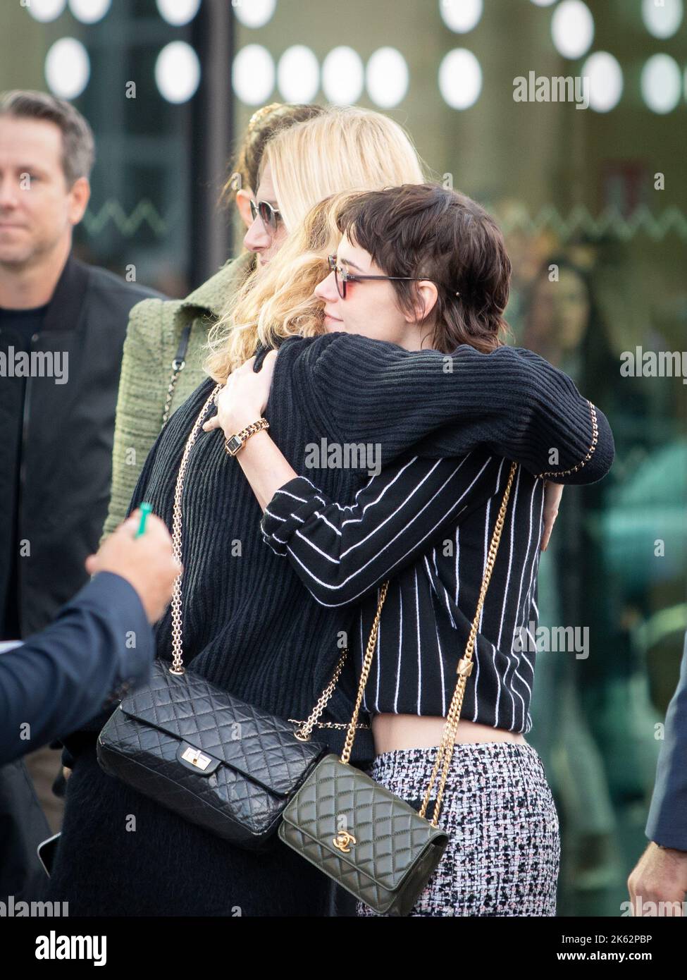 The actress Kristen Stewart hugging a guest at the Chanel Womenswear Spring/Summer 2023 show Paris Fashion Week on October 04, 2022 Stock Photo