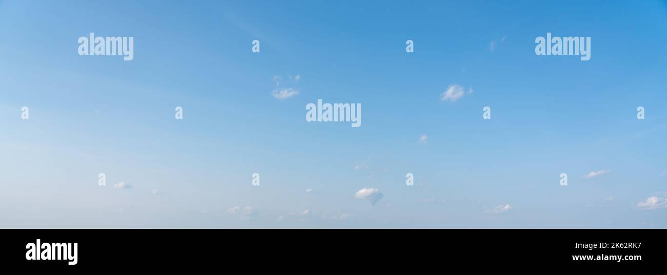 Blue panoramic sky background with small white clouds Stock Photo
