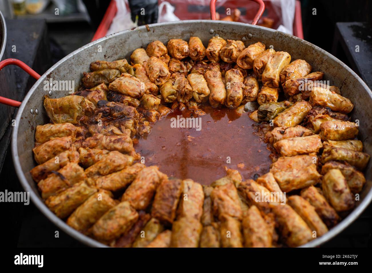 Shallow depth of field (selective focus) details with a big pot of sarmale, Romanian traditional cabbage rolls filled with minced meat, in a farmers m Stock Photo