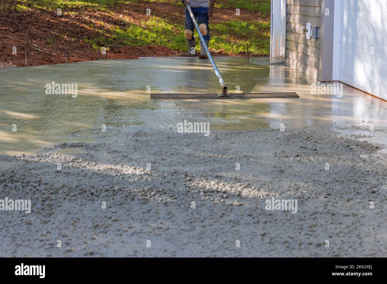 Mason worker plastered the leveling cement concrete patio floor using