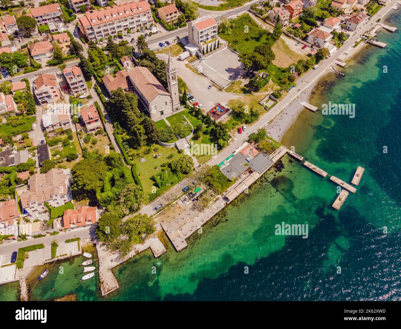 Montenegro. Boka Kotor Gulf. View on the picturesque coastal town of Dobrota, the Institute of Marine Biology and the Church of St. Ilijah Stock Photo
