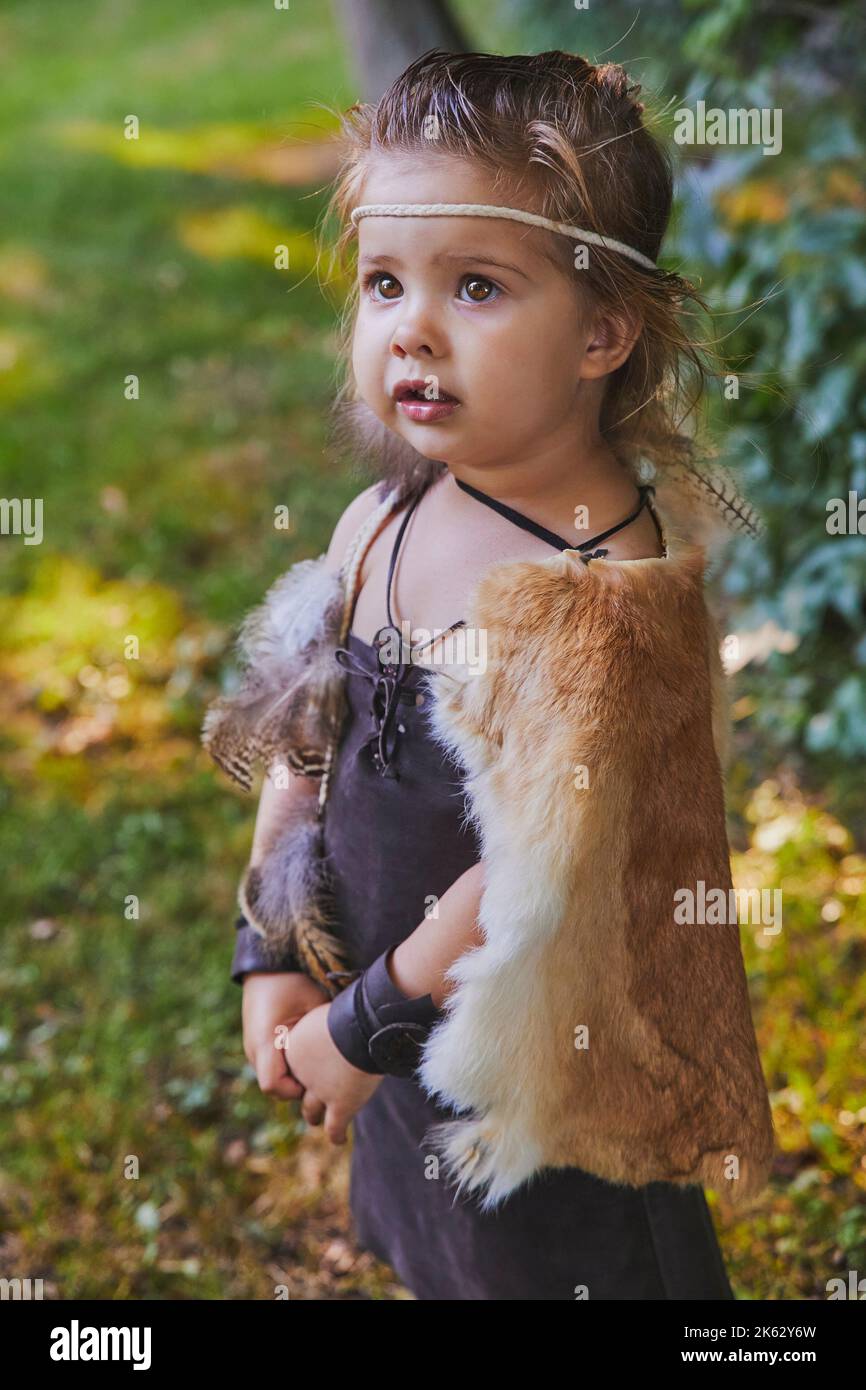 Cute baby dressed in the clothes of primitive people Stock Photo