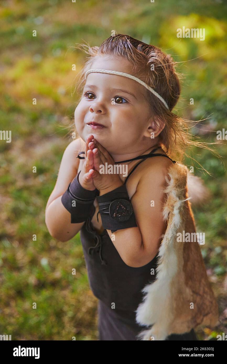 Cute baby dressed in the clothes of primitive people Stock Photo