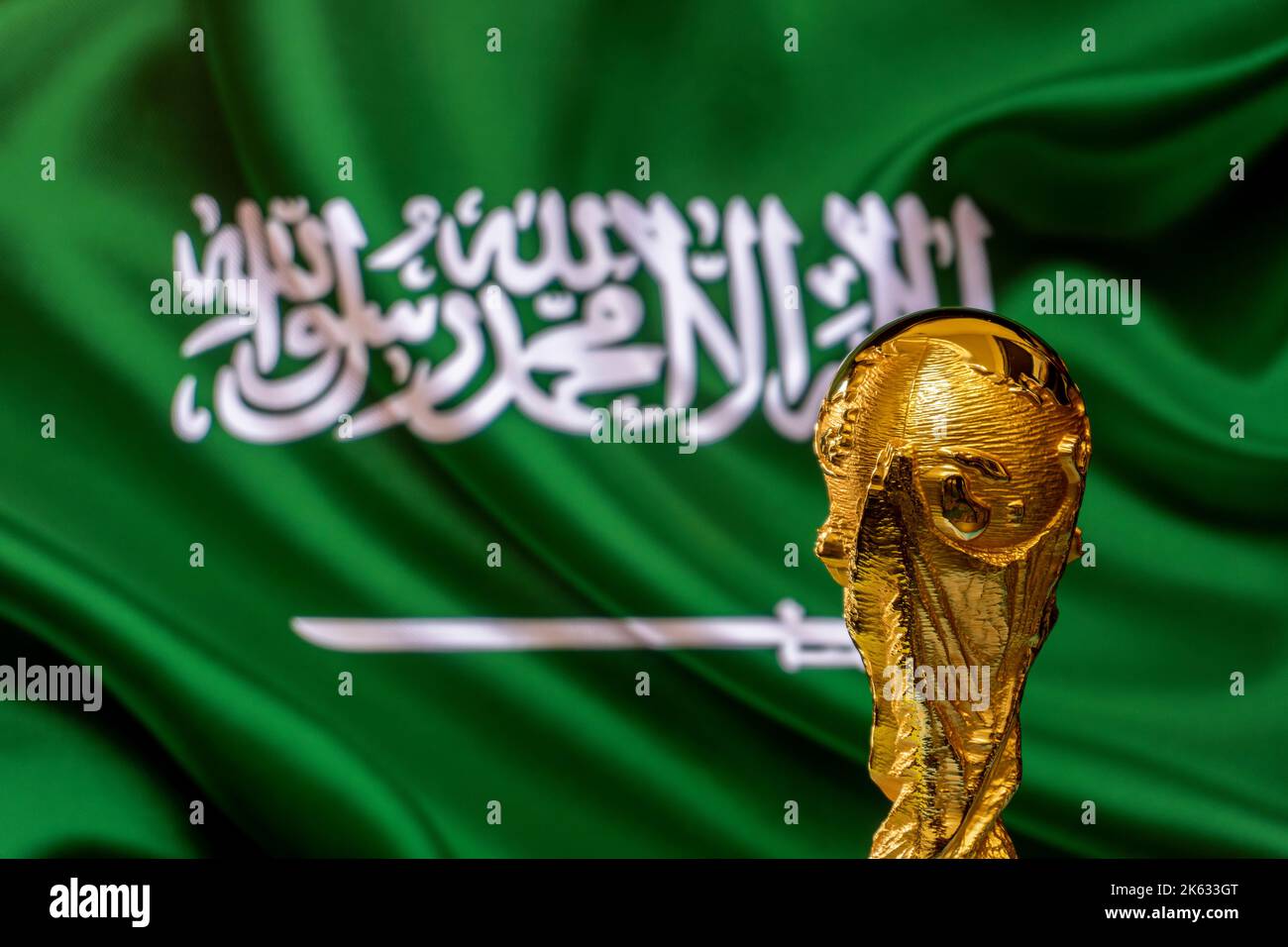 FIFA World Cup trophy against the background of Saudi Arabia flag. Stock Photo